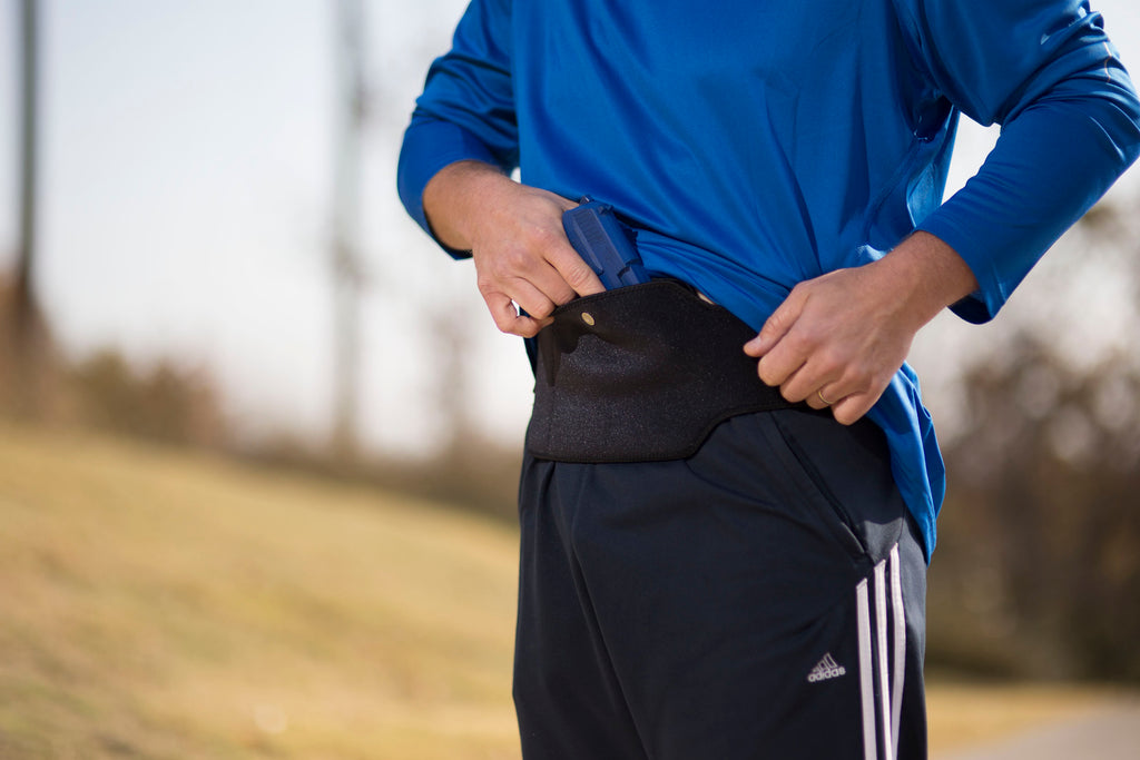 A man wearing fitness clothes and a PT-ONE breathable waistband holster close-up with cushioned comfort for discreet concealed carry.
