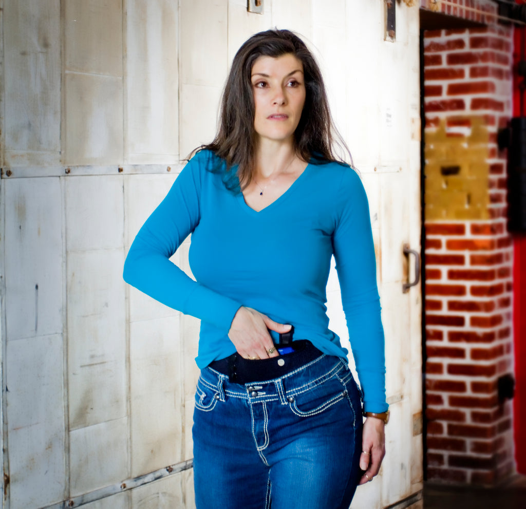 Casual female wearing Lady Defender holster at waist with cushioned comfort for discreet concealed carry